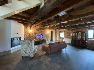 a living room with a couch and a tv at CASA PEINADO in Boimorto
