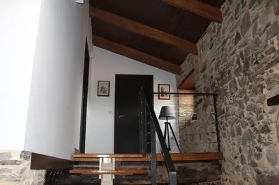 a staircase in a house with a stone wall at CASA PEINADO in Boimorto