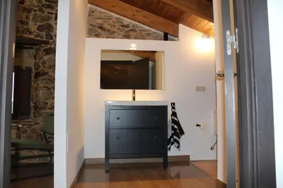 a black dresser in a room with a mirror at CASA PEINADO in Boimorto