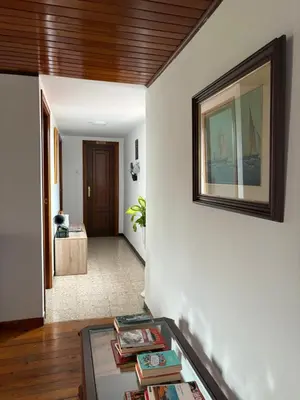 a living room with a picture on the wall at A casa do Rio - The River House in Arzúa