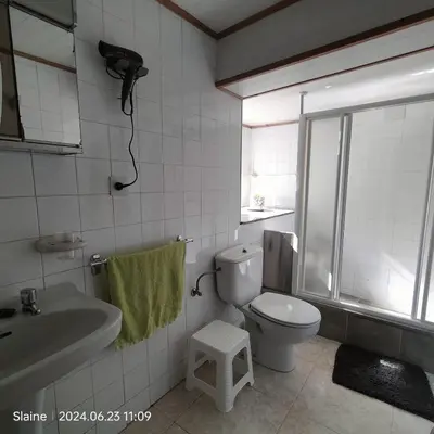 a bathroom with a toilet and a sink and a shower at A casa do Rio - The River House in Arzúa