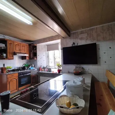 a kitchen with a sink and a counter top at A casa do Rio - The River House in Arzúa