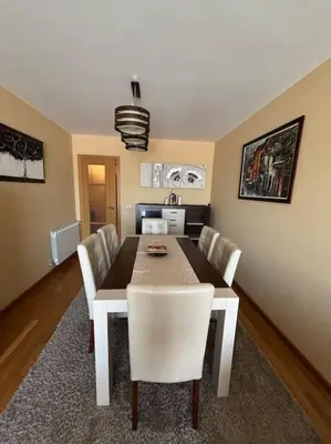 a dining room with a table and white chairs at Refuxio Xacobeo - Apartamento céntrico en Sarria in Sarria