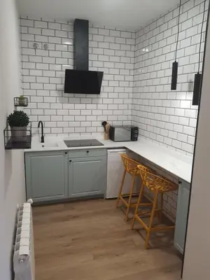 a kitchen with a sink and a counter with stools at Pensión CREDENCIAL in Sarria