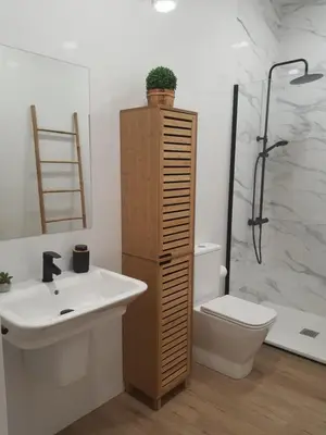 a bathroom with a sink and a toilet and a shower at Pensión CREDENCIAL in Sarria