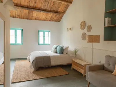 a bedroom with a bed and a couch at Casa Marela in Rinlo