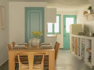 a dining room with a table and chairs in a kitchen at Casa Marela in Rinlo
