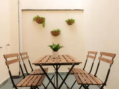 a table and chairs with plants on a wall at Casa Marela in Rinlo