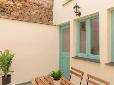 a house with a blue door and two chairs at Casa Marela in Rinlo
