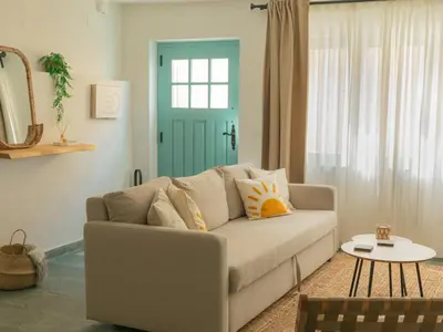 a living room with a couch and a blue door at Casa Marela in Rinlo