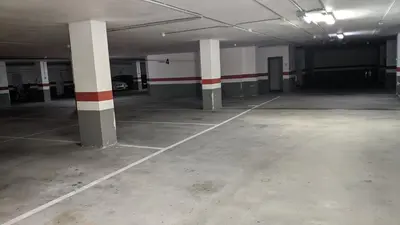 an empty parking garage with white and red columns at FOZLIDAYS! Apartamento, parking & relax in Foz