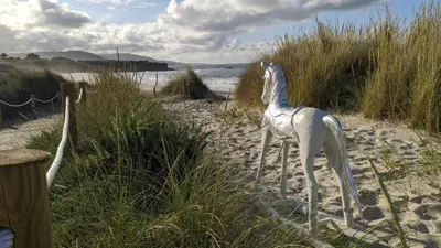 a statue of a plastic chair on a beach at FOZLIDAYS! Apartamento, parking & relax in Foz