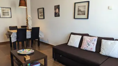 a living room with a couch and a table at FOZLIDAYS! Apartamento, parking & relax in Foz