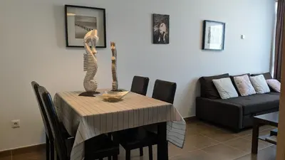 a living room with a table and a couch at FOZLIDAYS! Apartamento, parking & relax in Foz