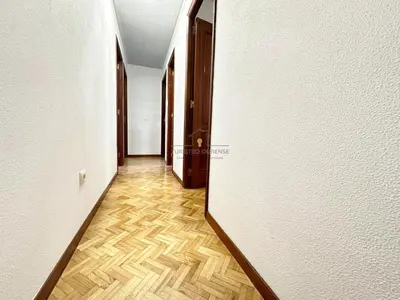 a hallway with a mirror and a wooden floor at O Rincón de Laly in Ourense