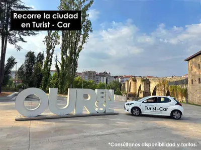 a white car parked in front of a sign at O Rincón de Laly in Ourense