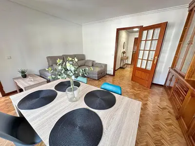 a living room with a table and a couch at O Rincón de Laly in Ourense