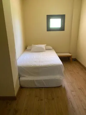 a bed in a small room with a window at A casa de Roque 1 in Miño