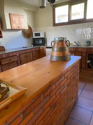 a kitchen with a wooden counter with a tea kettle on it at A casa de Roque 1 in Miño