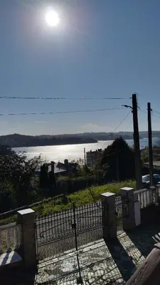 a gate with a view of a body of water at A casa de Roque 1 in Miño