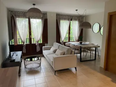 a living room with a white couch and a table at El Puerto in figueras
