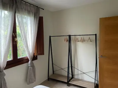 a room with a mirror and a window at El Puerto in figueras