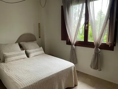 a bedroom with a bed and a window at El Puerto in figueras