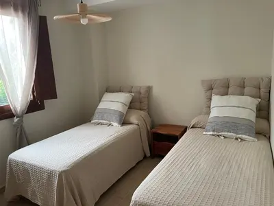 a bedroom with two beds and a window at El Puerto in figueras