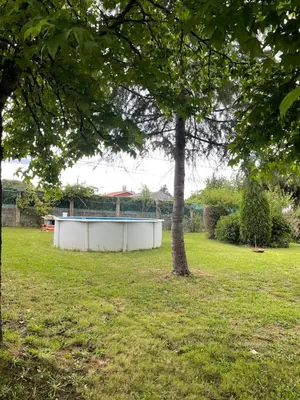 a large white tub sitting in a field next to a tree at La Fincurri del Nando in A Coruña