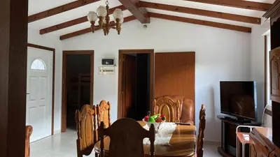 a dining room with a table and chairs and a television at La Fincurri del Nando in A Coruña