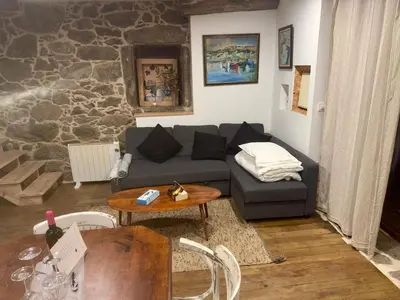 a living room with a couch and a table at Lagar de Guxeva in Chantada