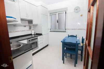 a kitchen with a blue table and a blue chair at CASA Conchita in Ribadeo