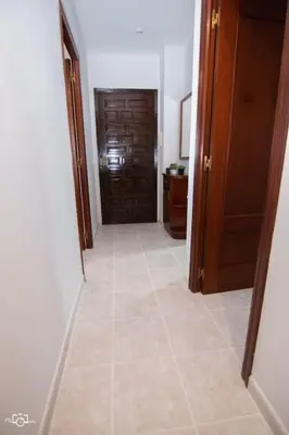 a hallway with a door and a tile floor at CASA Conchita in Ribadeo