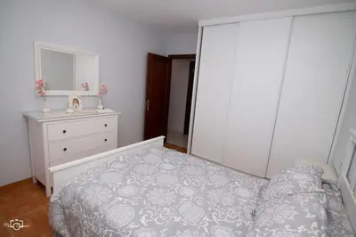 a bedroom with a bed and a dresser and a mirror at CASA Conchita in Ribadeo