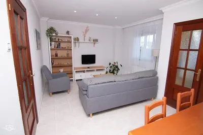 a living room with a couch and a television at CASA Conchita in Ribadeo