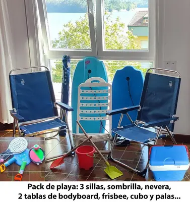 a group of chairs sitting in front of a window at Piso Dos Playas Miño in Miño