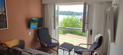 a living room with a couch and chairs and a large window at Piso Dos Playas Miño in Miño