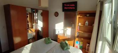 a bedroom with a bed with green shoes on it at Piso Dos Playas Miño in Miño