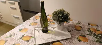 a bottle of wine and two glasses on a table at Piso Dos Playas Miño in Miño