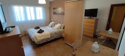 a bedroom with a bed with a cat laying on it at Piso Dos Playas Miño in Miño