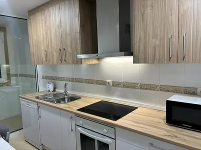 a kitchen with a sink and a counter top at Alesamar A in Burela de Cabo