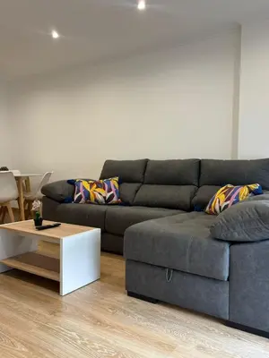 a living room with a couch and a coffee table at alesamar B in Burela de Cabo