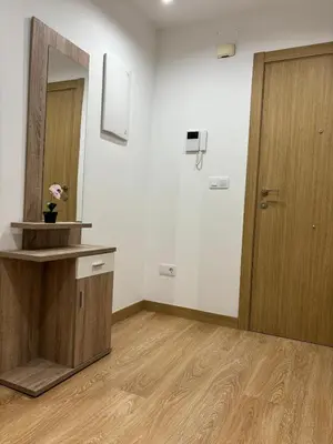 an empty room with a mirror and a wooden door at alesamar B in Burela de Cabo