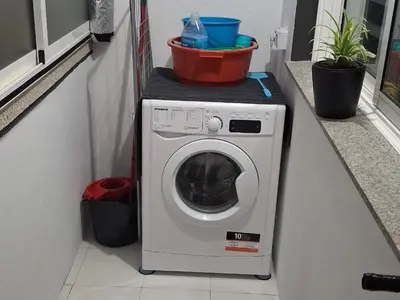 a washing machine with a bucket on top of it at Paradita del camino in Sarria