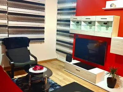 a living room with a tv and a chair at Paradita del camino in Sarria