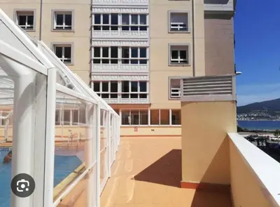 a view of a building from the balcony of a building at Apartamento Maremágnum in Viveiro