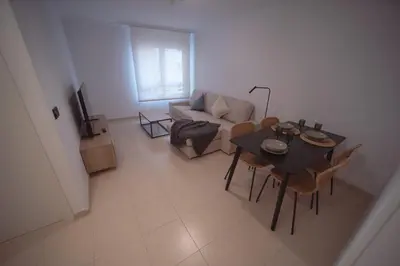 a living room with a table and a couch at Apartamento Maremágnum in Viveiro