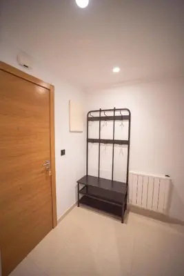 a empty room with a wooden door and a white wall at Apartamento Maremágnum in Viveiro