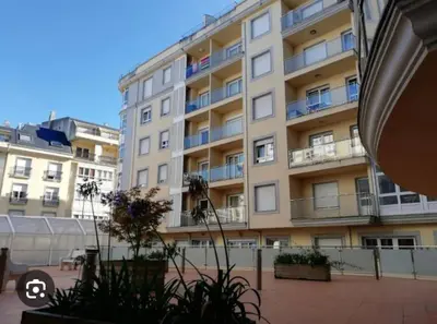 a large building with balconies and plants in front of it at Apartamento Maremágnum in Viveiro