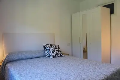 a bedroom with a bed with a blue comforter at Casa dos avós in Ribadavia